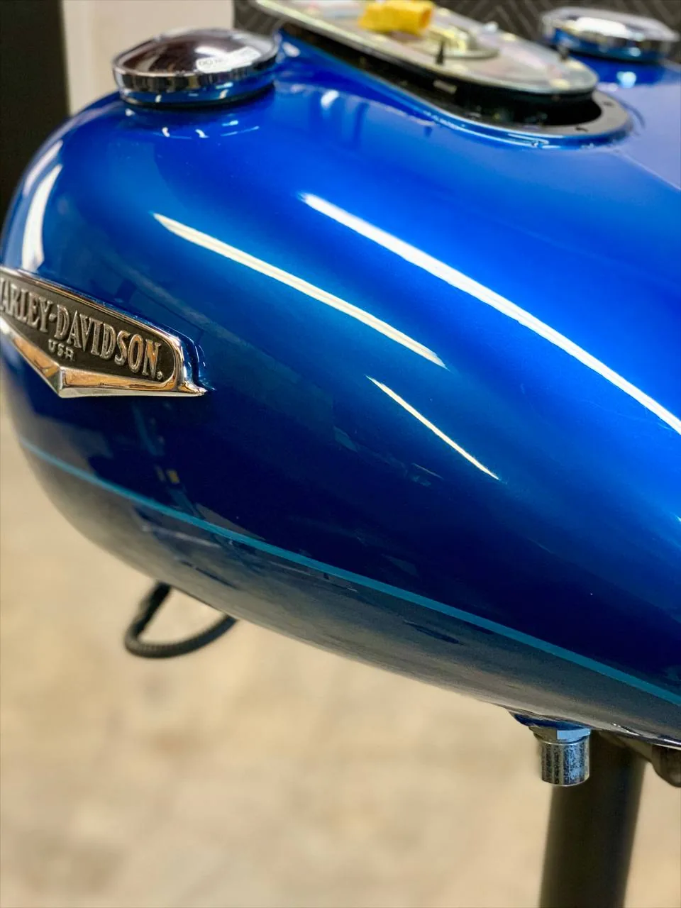 Harley Davidson tank after paintless dent repair, factory paint preserved, Upland California