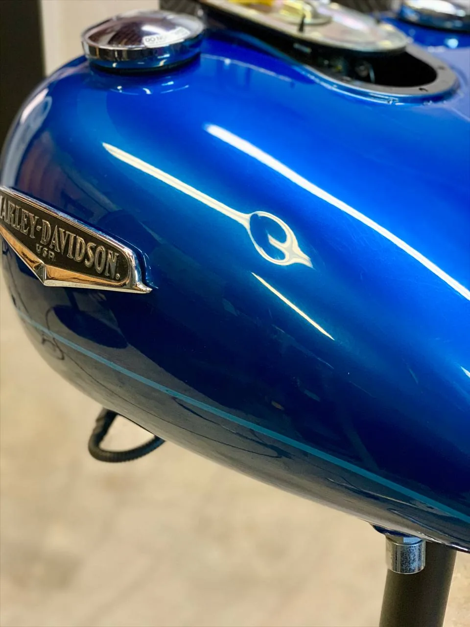 Harley Davidson tank dent before paintless dent repair, Upland California