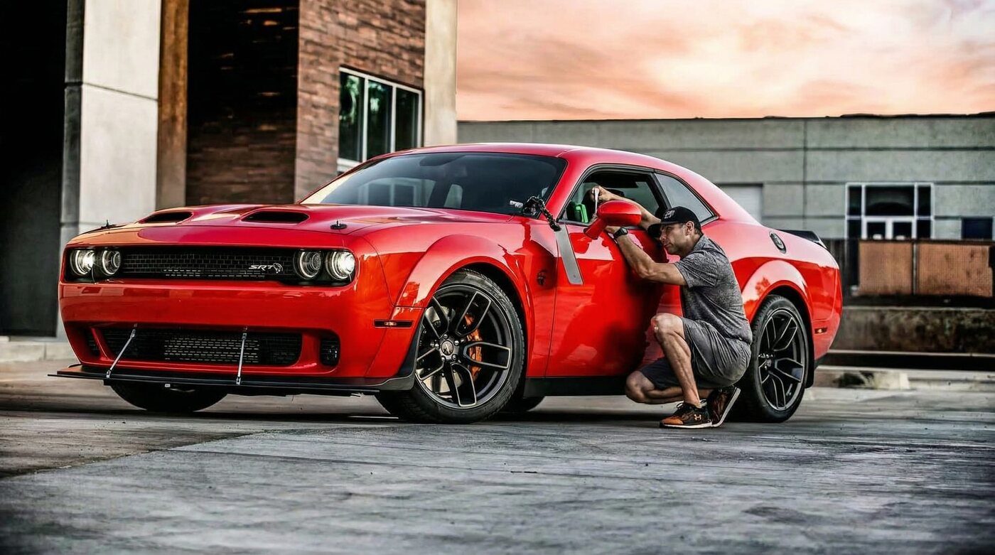 Joe Garcia performing paintless dent repair on a red Dodge Challenger Hellcat in Upland, CA