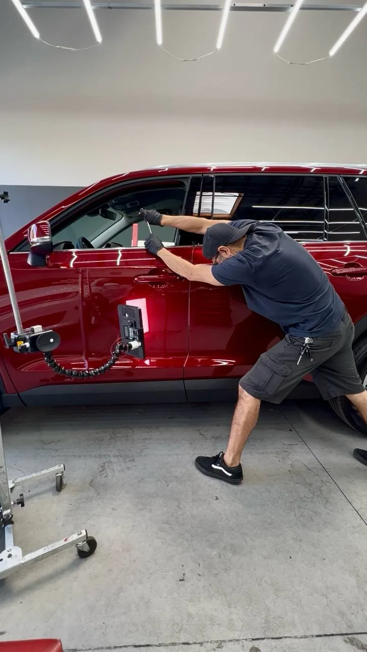 Paintless dent repair on an SUV in Upland, California