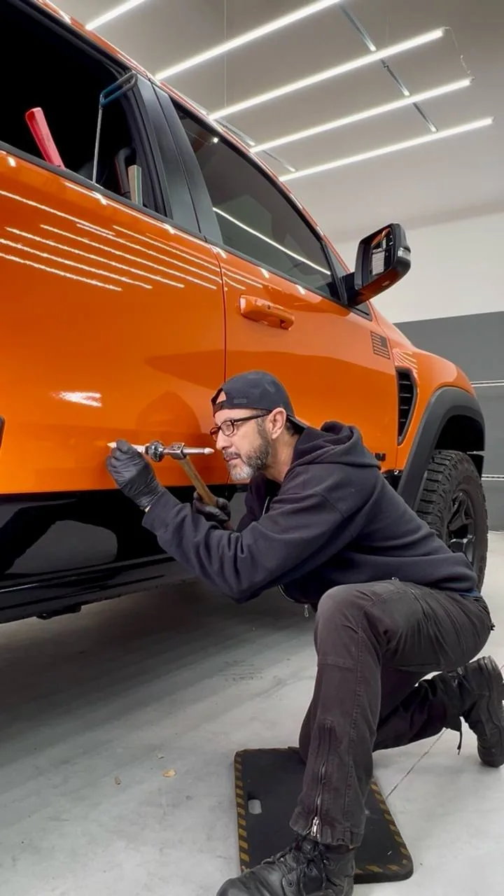 Paintless dent repair on a truck door in Upland, California